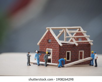 Miniature People Working To Build The House, They Work To Finish This Project