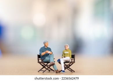 Miniature people ,Young couple sitting on chair listening music and drinking coffee, Valentine's day concept - Powered by Shutterstock