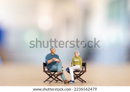 Miniature people ,Young couple sitting on chair listening music and drinking coffee, Valentine's day concept