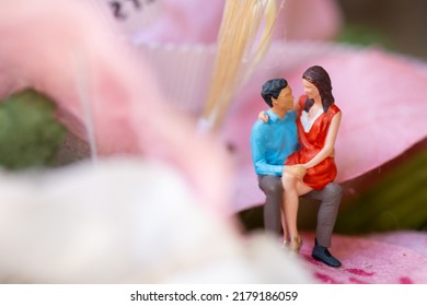 Miniature People Young Girl Sitting On Her Boy Lap, Affectionate Couple Sitting On Flower