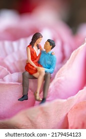 Miniature People Young Girl Sitting On Her Boy Lap, Affectionate Couple Sitting On Flower