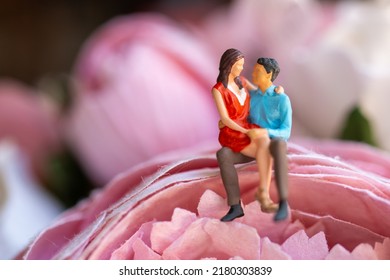 Miniature People Young Girl Sitting On Her Boy Lap, Affectionate Couple Sitting On Flower