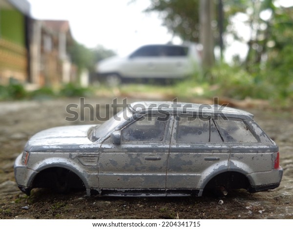  A\
miniature photograph of a miniature car in the\
yard