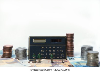 Miniature Police Officers Guard A Calculator Surrounded By Money. White Background, Copy Space