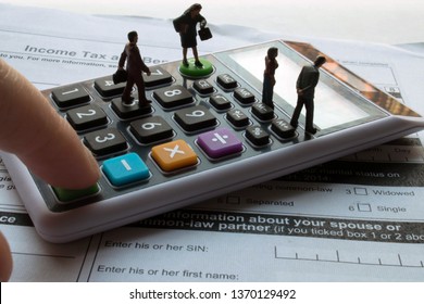 Miniature professional tax accountant or preparer on calculator. Blank tax forms ready to be filled out. Tiny team of men and women to help with your personal or small business taxes. Hire a tax pro.