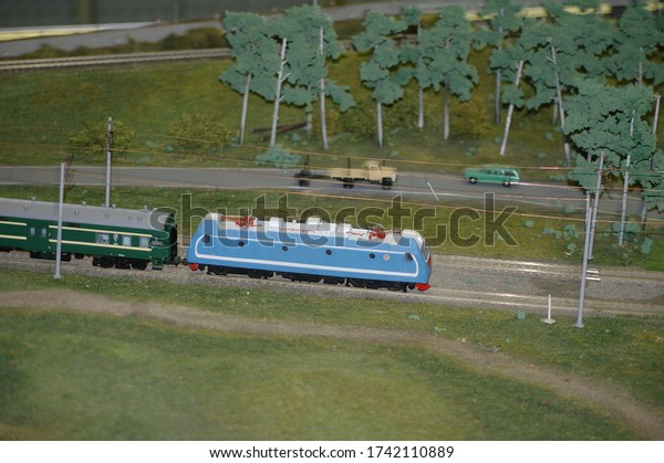 miniature railway\
train going through the\
forest