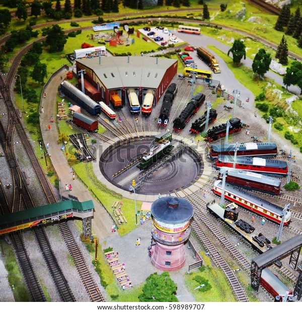 Miniature\
railway train station model with many\
trains.