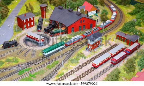 Miniature railway train station model with\
railway depot and\
trains.