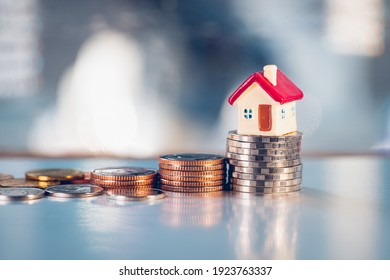 Miniature Red House On Stack Coins Using As Property Real Estate And Business Financial Concept