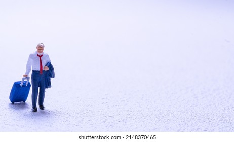 A miniature of a salaryman traveling with a travel bag alone - Shutterstock ID 2148370465