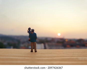 Miniature scene of father and son enjoying sunset time. Blurred sunset view, conceptual design photography. - Shutterstock ID 2097426367