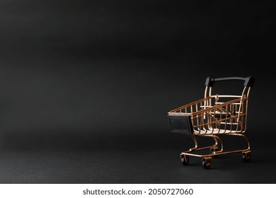 Miniature shopping chart or trolley isolated on black background with copy space - Powered by Shutterstock