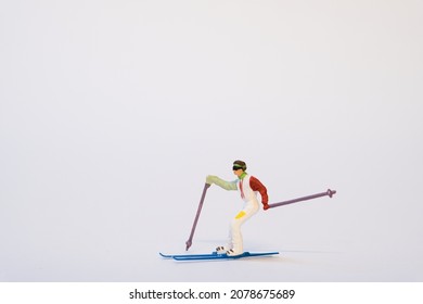miniature skier on white background - Shutterstock ID 2078675689