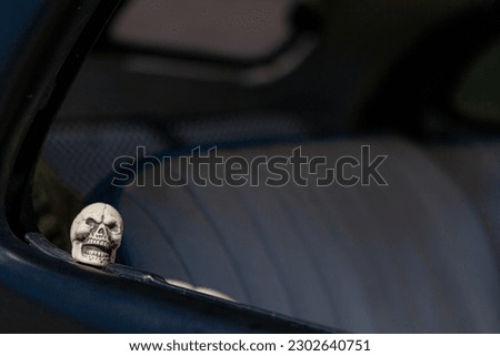 Miniature skull head rides in the back of a hot rod in Mesquite NV 