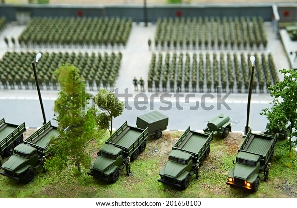 Miniature of soldiers in ranks and fighting\
machines close-up