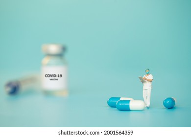 Miniature support team, Doctor emergency medical team wear surgical mask with pills and blue sea background. Health care, life insurance for covid-19 concept. Report and data science - Powered by Shutterstock