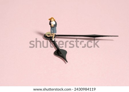 Miniature tiny people toy photography. A girl student wearing school uniform running above clockwise. Isolated on pink background. Image photo