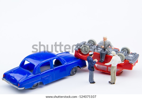 Miniature tiny toys car crash accident\
damaged.Insurance on the road.Driving safety do not\
underestimate.Accident on the road\
background