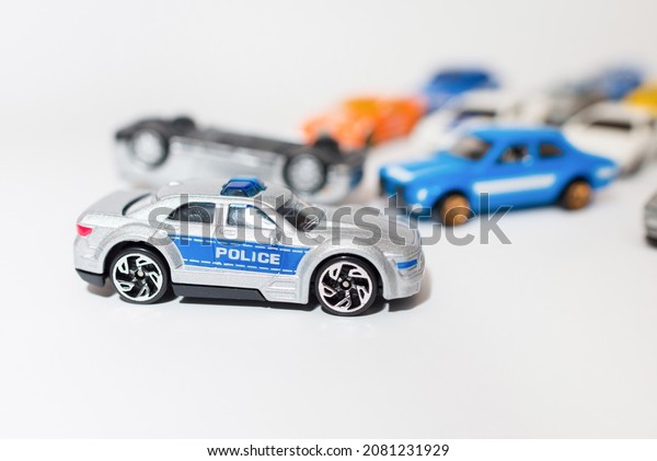 Miniature toy car in accident and\
police car on white background.Copy space,selective\
focus.