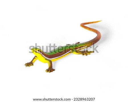 Miniature toy lizard animal yellow brown green isolated on white
