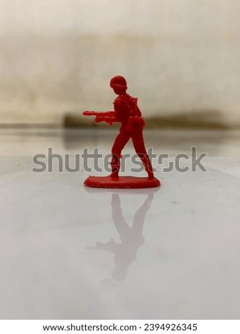 a miniature toy soldier holding a firearm
