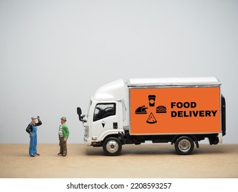 Miniature toy at table with white background. Concept of fast food delivery service. Supermarket, cafe, restaurant, groceries products, bread, meat, milk, fruit, vegetable and drinks. - Shutterstock ID 2208593257