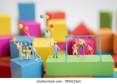 Miniature Toy.Family Play With Parents On Multi Color Wood Block.Family Concept.