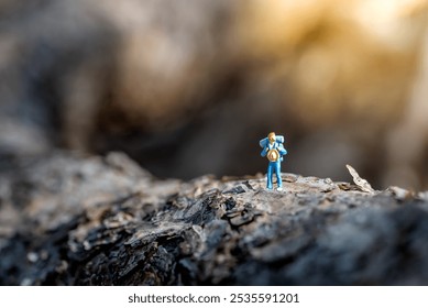 Miniature traveler exploring nature, symbolizing the joy of solo travel and the pursuit of adventure in the great outdoors - Powered by Shutterstock