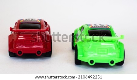 Miniature two racing cars in red and green in various styles.