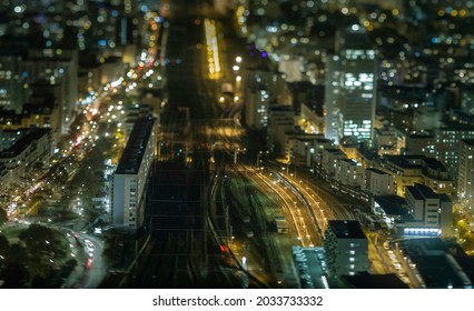 A miniature view of Paris at night from a tower using tilt-shift photography technique