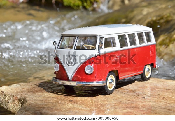 Miniature VW Bulli 1962 in the forest. The cult\
car of the Hippie generation and it remained the status vehicle of\
the high wave surfers