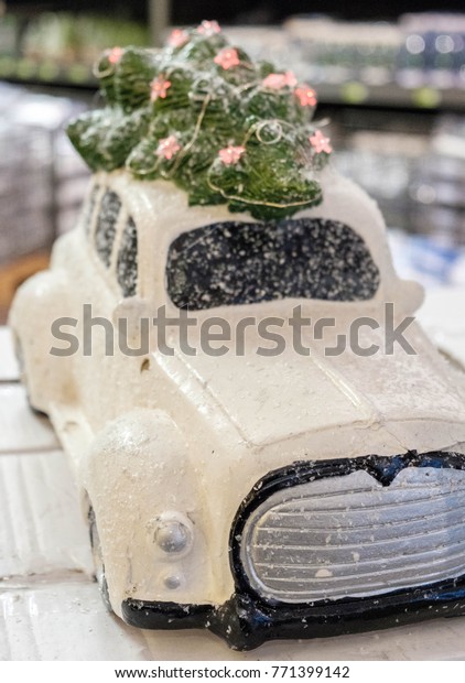 Miniature of white auto with Christmas tree on\
top, Christmas\
concept.