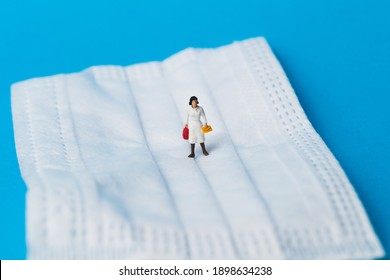 Miniature Women Walking On Surgical Mask