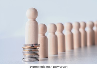 Miniature wooden figures of people standing on stack of coins. Inequality and social class. Income and economic inequality concept. Inequality in social class, ideology and health. Financial growth