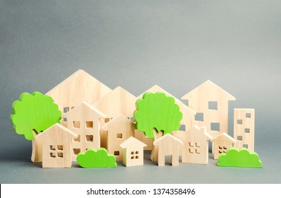 Miniature Wooden Toy Houses And Trees. Real Estate Concept. Architecture In The City. Infrastructure. Affordable Housing. Construction Of New Buildings. City Greening. Renovations And Recovery