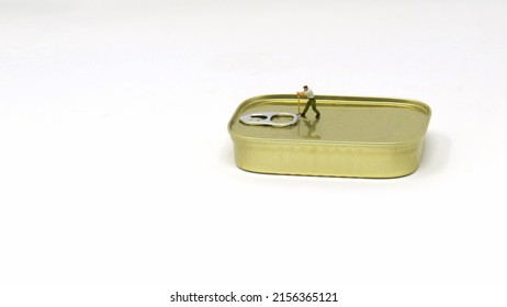 Miniature Worker Prying Open Sardine Can