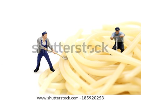 Miniature worker work with spaghetti