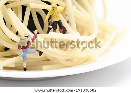 Miniature worker work with spaghetti