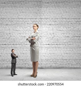 Miniature of young businessman and bossy businesswoman - Shutterstock ID 220970554