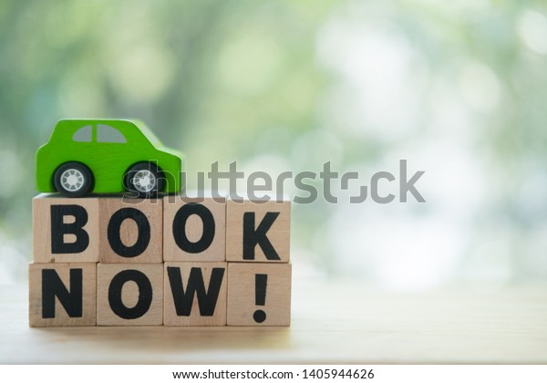 Miniatures car and words\
with book now. Concept of online car booking. Book taxi cab online\
internet booking