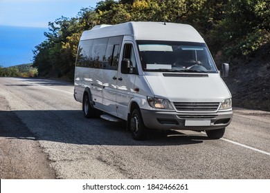 Minibus Moves on the road from the sea in summer