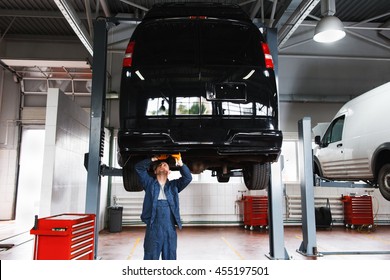 Minibus Service Maintenance, Professional Garage Interior, Lifted Car On Elevator