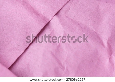 Minimal abstract background featuring softly folded pink paper with delicate creases and handmade texture. Feminine pastel backdrop ideal for branding, stationery and creative design.