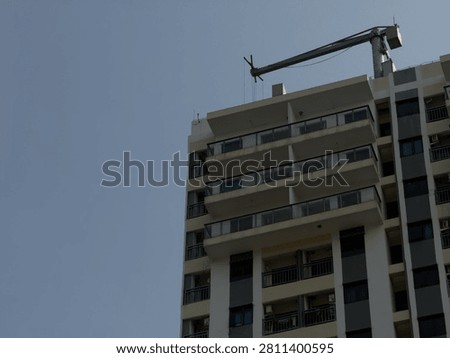 Minimal architectural wall with a soft blue sky, creating a balanced composition and modern visual simplicity.