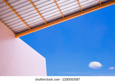 Minimal architecture background of arcade roof with beige building against blue sky in bottom view