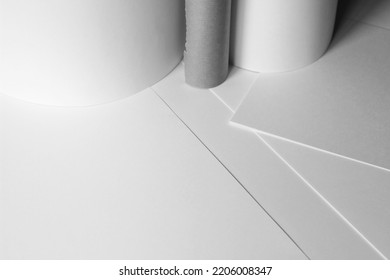 Minimal Business Design Copy Space Mockup. Blank Paper Rolls And Paper Sheets On Office Desk. Design Studio Space.
