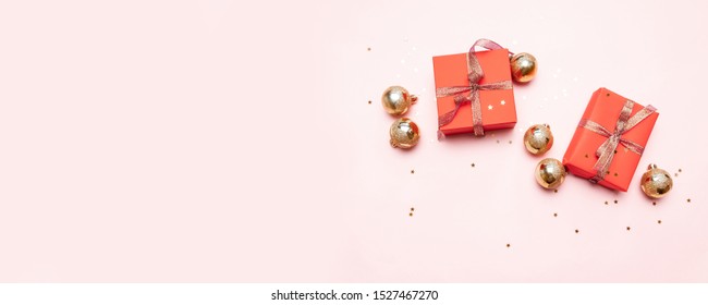 Minimal Christmas Newyear Concept Of Christmas Red Gift Boxes, Balls On Pastel Pink Background. Creative Flat Lay, Top View Design