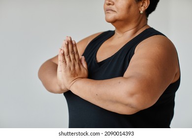 Minimal Close Up Of Black Senior Woman Meditating While Doing Yoga Indoors, Focus On Hands In Balance