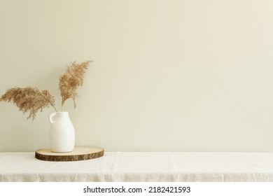 Minimal Composition Of Scandinavian Style Interior, White Vase With Pampas Grass On Table With Linen Tablecloth, Blank Wall Mockup, Free Space For Design Or Art Presentation.