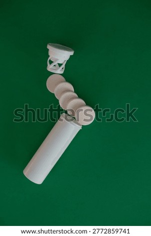 Minimal composition of tablets falling from a container on green surface, symbolizing dosage, treatment, medical decisions and healthcare themes.